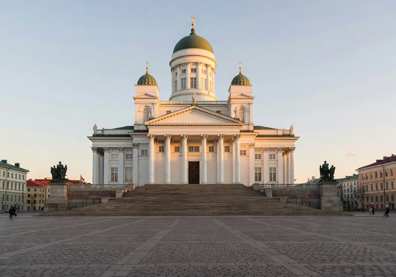 The iconic white Helsinki Cathedral dominating the city square under a blue sky
